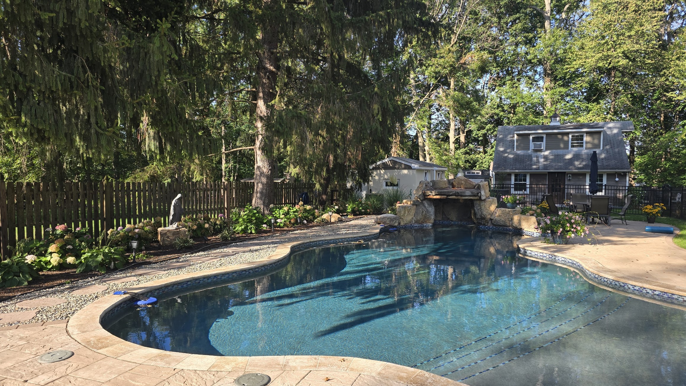 Custom pool with rock waterfall feature